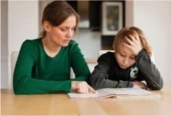 A woman and boy at a table reading a book - B2 First Speaking Part 2