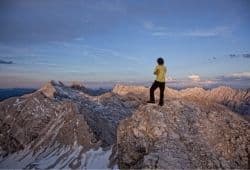 A man looking into the distance on a mountain peak - B2 First Speaking Part 2