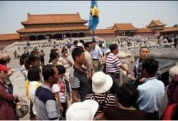 A small crowd of people at the Forbidden City listening to a tour guide - B2 First Speaking Part 2