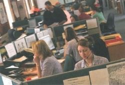 C1 Advanced Speaking Part 2 - An open plan office with many workers at their desks.