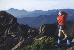 A photographer taking a photo at the top of a mountain range - B2 First Speaking Part 2