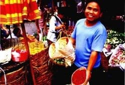 C1 Advanced Speaking Part 2 - A man in a blue t-shirt showing what flowers he wants to sell