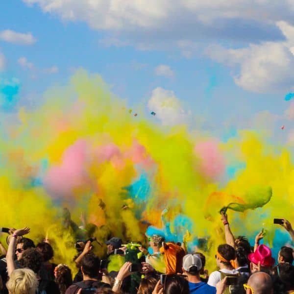 Clouds of colour outside over a crowd of people