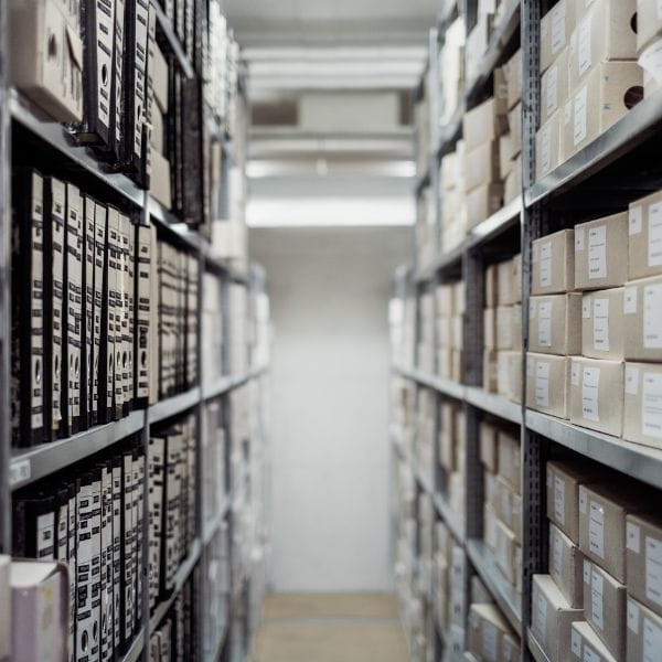 high shelves of files on both sides going into the distance