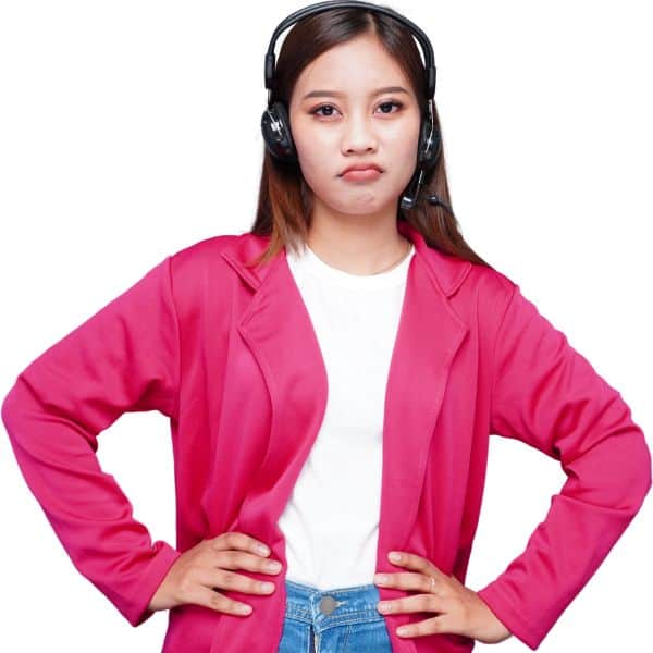 Dark haired young woman in an open pink shirt, a white T-shirt and blue jeans with her hands on her hips and pouting - How to Write an IELTS Task 2 Essay