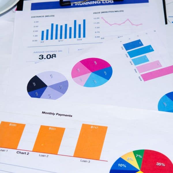 Various papers showing pie charts, bar graphs and more -IELTS Writing Task 2 Questions