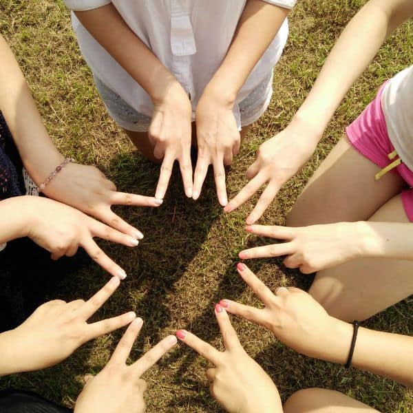 10 hands using two fingers each to make a multi-pointed star - B2 First Grammar Fix it Now!