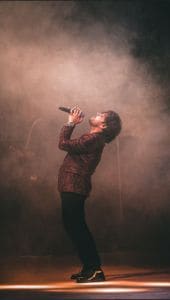 Singer onstage - What might motivate these people to take part in these activities? - C1 Advanced Speaking Part 2 Question Singer onstage - What might motivate these people to take part in these activities? - C1 Advanced Speaking Part 2 Question
